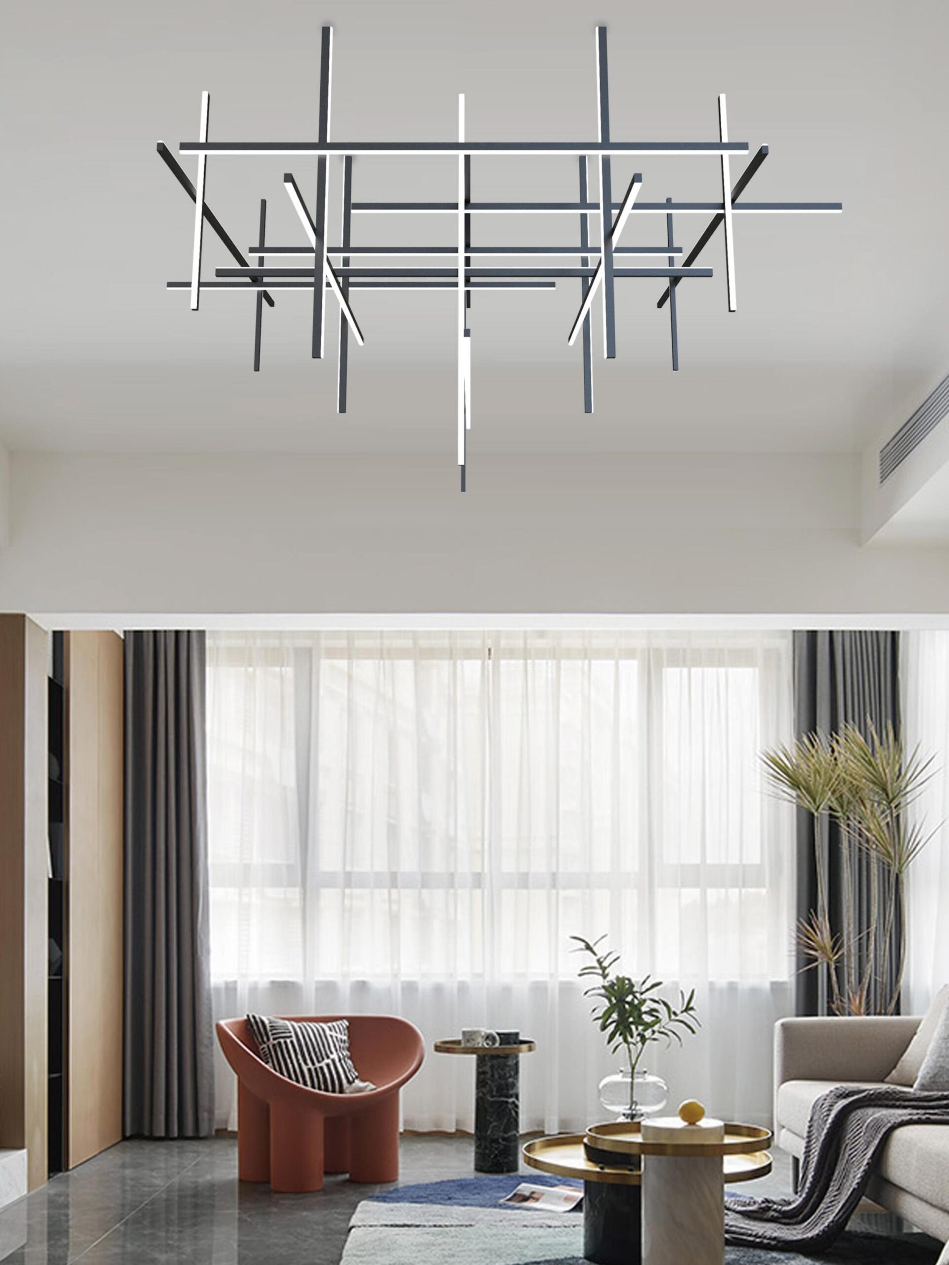 Black minimalist tubular pendant light in a bright modern living room.